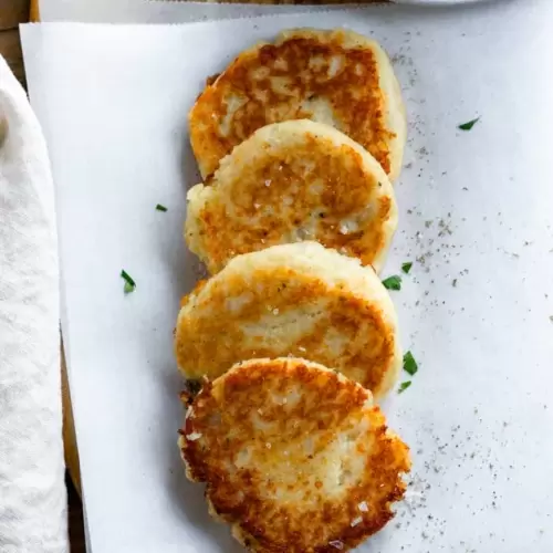 Potato pancakes slightly layered on top of each other.