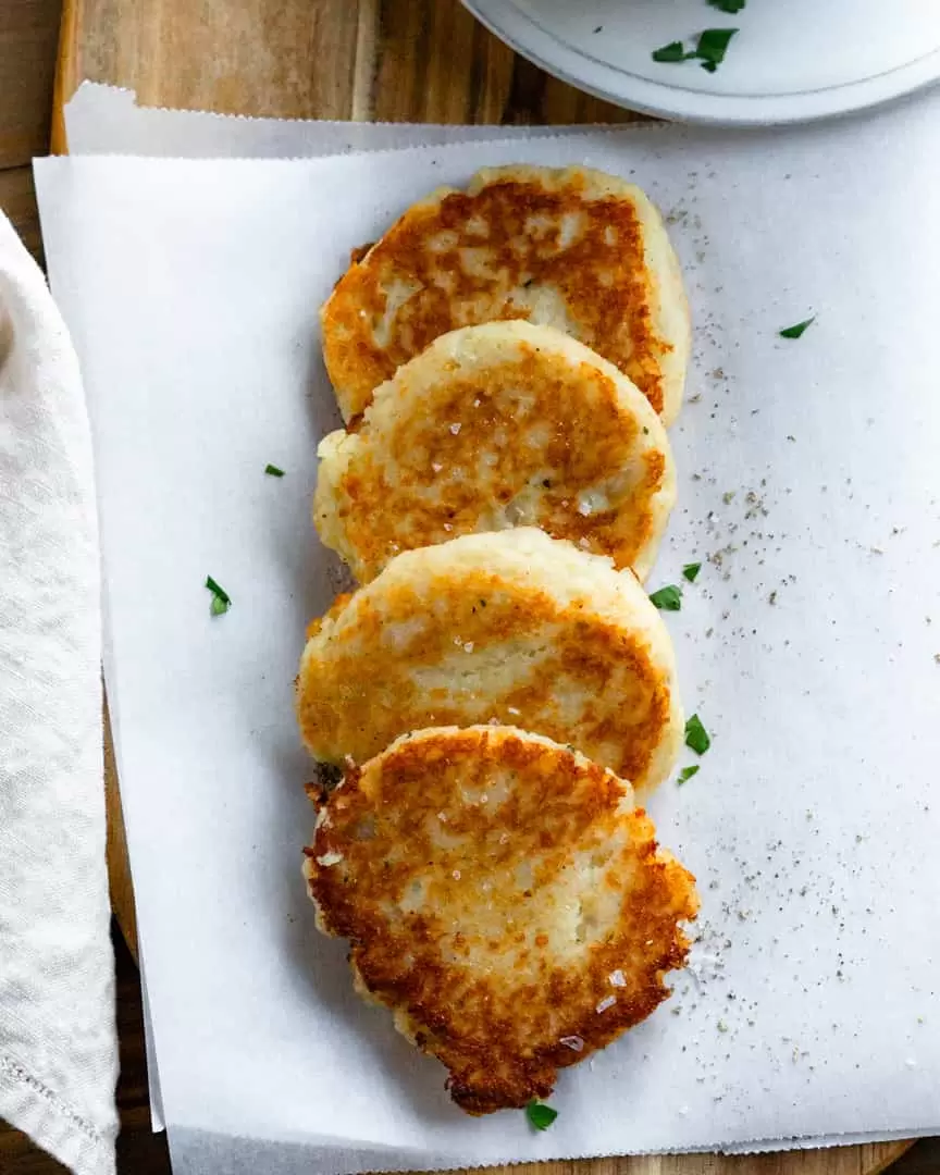 Potato pancakes slightly layered on top of each other.