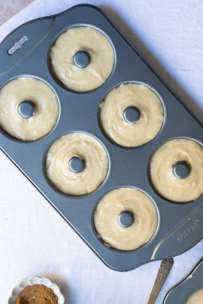 A donut pan with filled with batter.