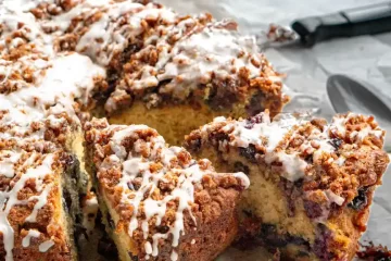 Slices of coffee cake that is pulled away from the rest of the cake