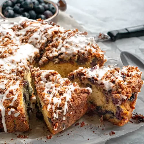 Slices of coffee cake that is pulled away from the rest of the cake