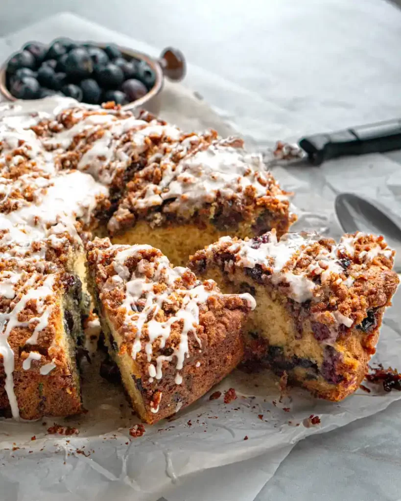 Slices of coffee cake that is pulled away from the rest of the cake