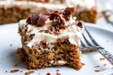 A sliced of cake on a plate with a fork.