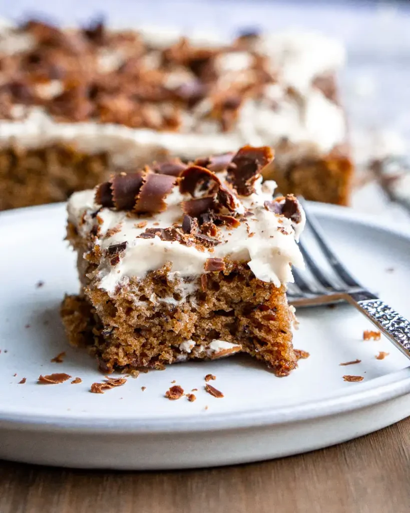 A sliced of cake on a plate with a fork.