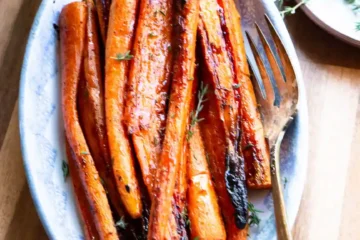 Glazed maple roasted carrots on a serving dish.