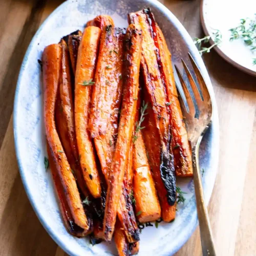 Glazed maple roasted carrots on a serving dish.