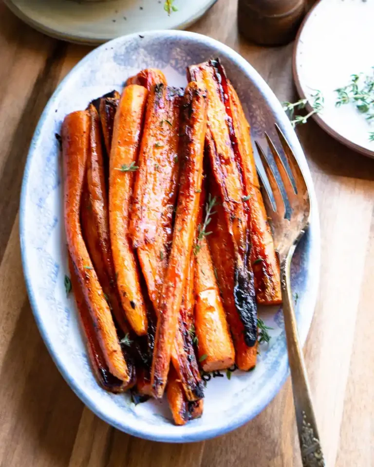 Glazed maple roasted carrots on a serving dish.