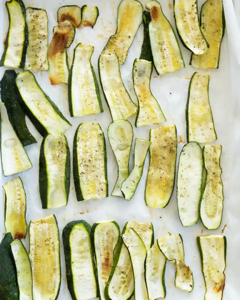 Roasted zucchini on a baking sheet.