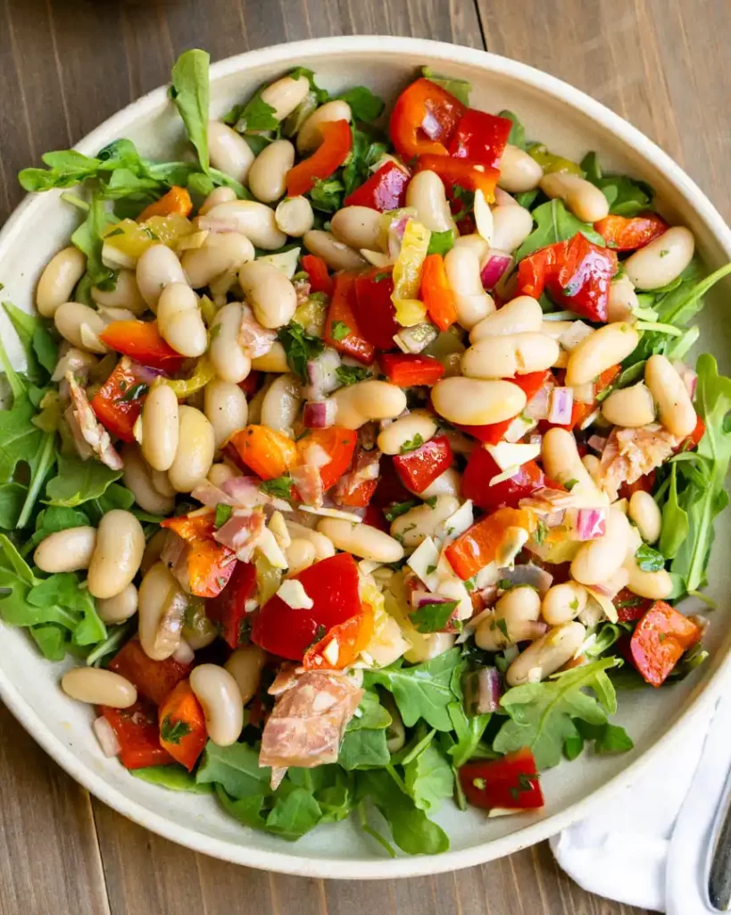 Italian grinder salad on a bed of arugula.