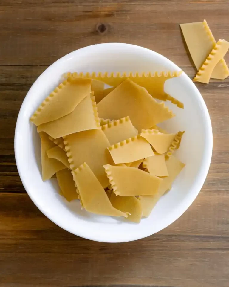 Dried broken lasagna noodles in a bowl.