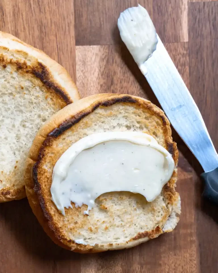 A toasted burger bun with a bit of garlic aioli