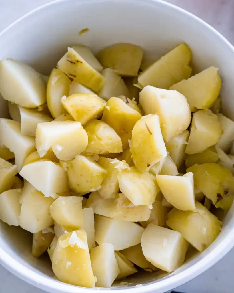 Bite size cubes of potatoes that have been peeled and boiled.