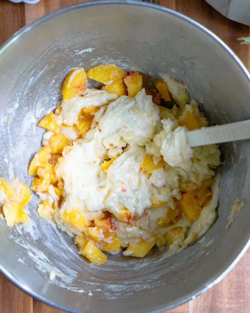 A bowl with peach muffin batter.