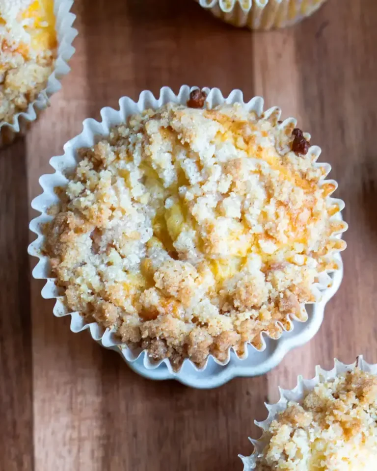 A top down view of a baked peach muffin.