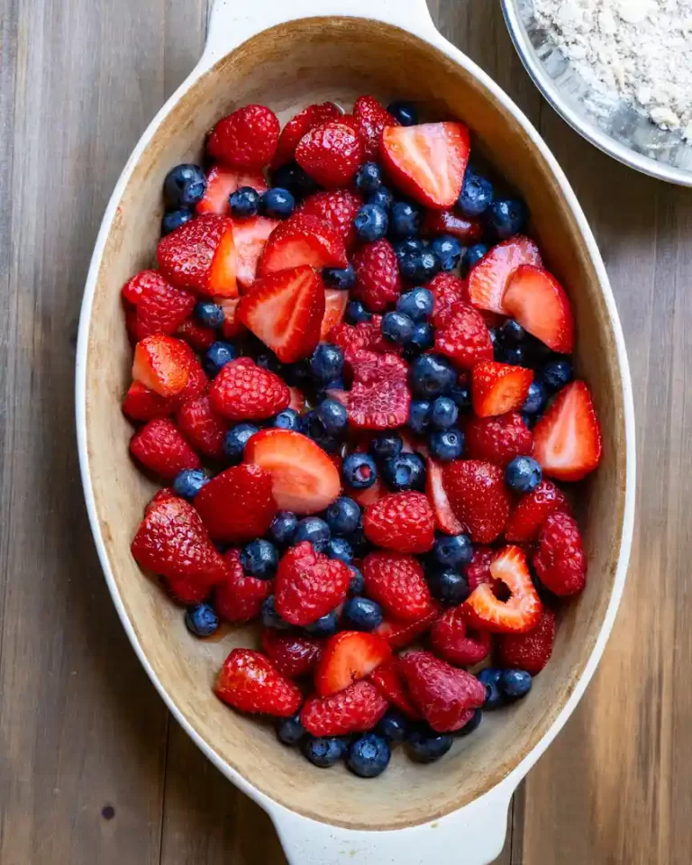 An oval baking dish filled with mixed berries.