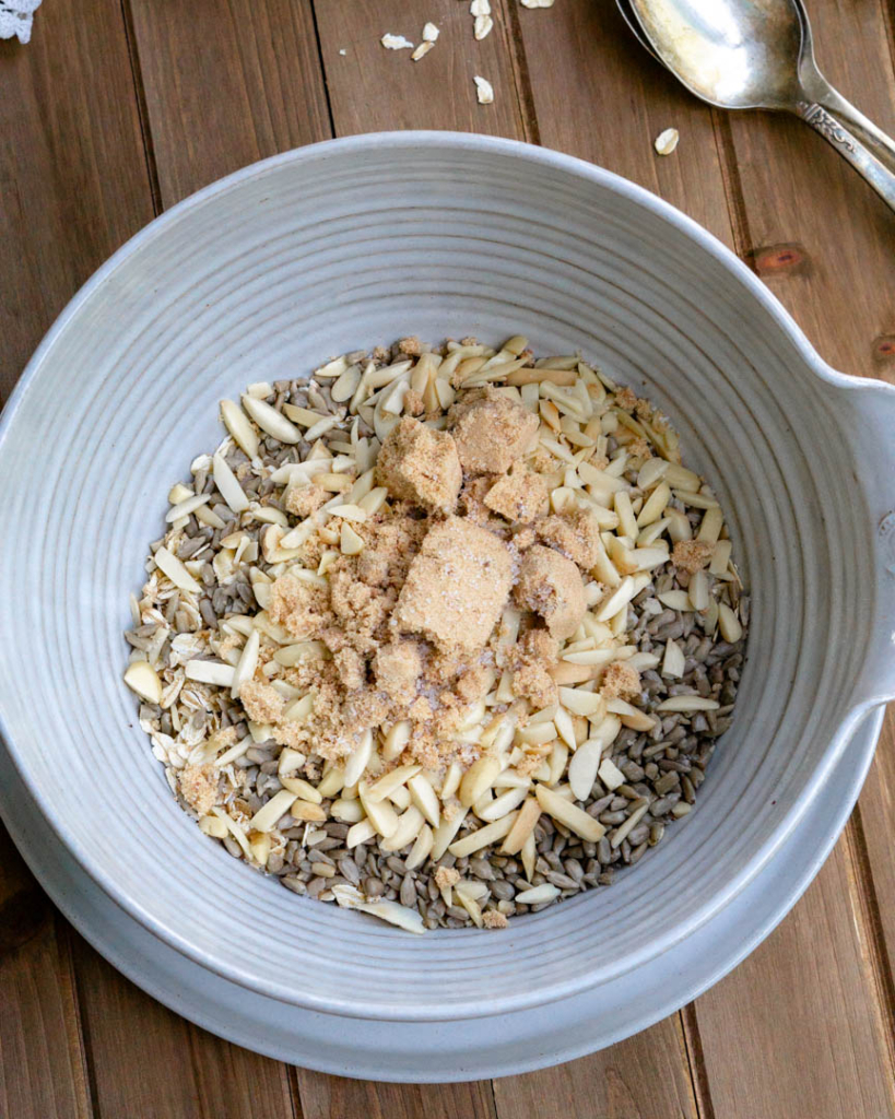 A bowl filled with dry granola ingredients.