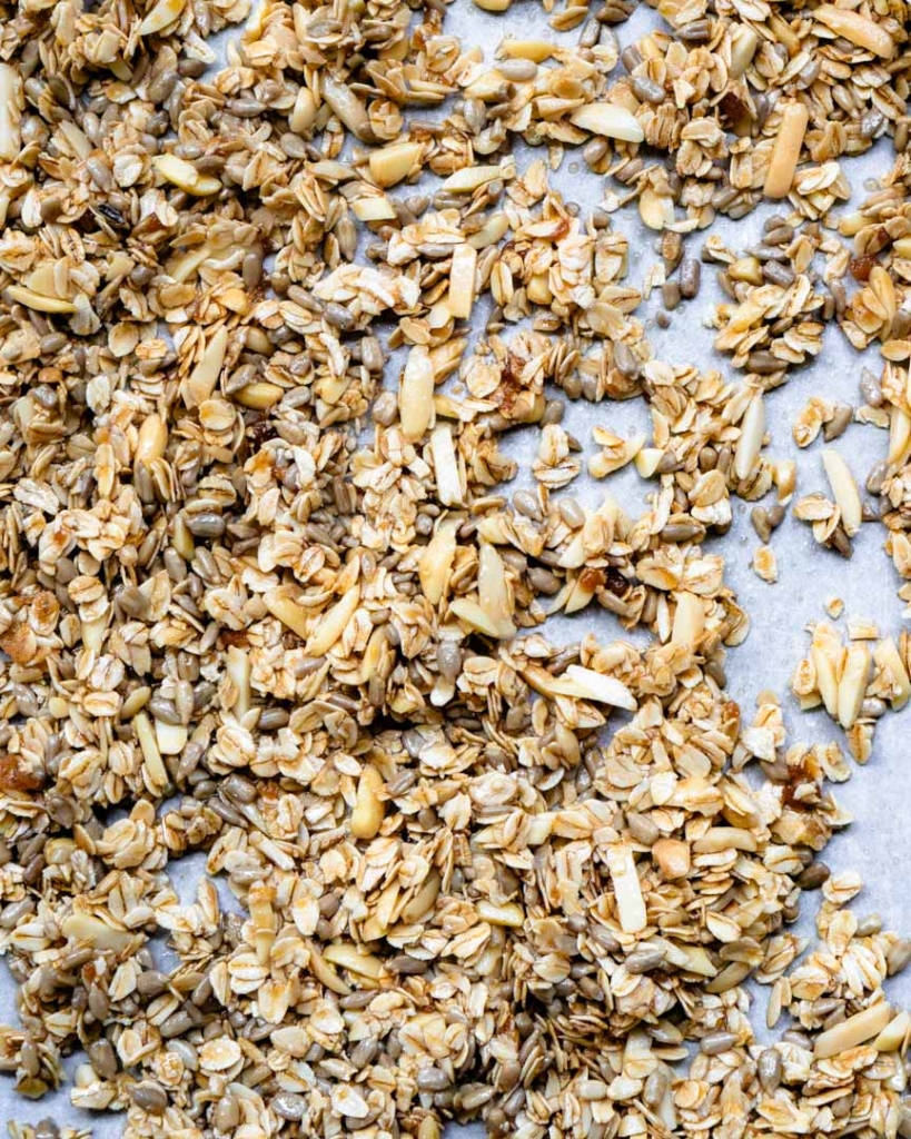 Unbaked granola on a on a baking sheet.