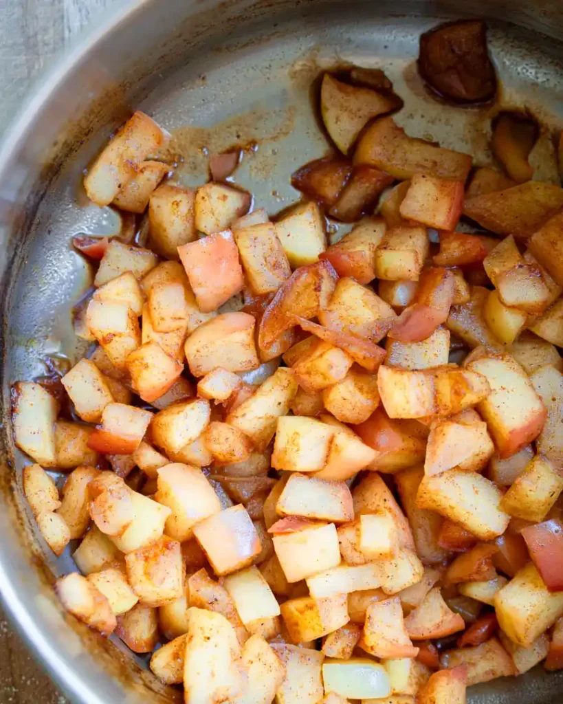 Cooked diced apples in a pot.