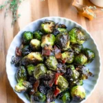 A bowl of roasted brussels sprouts with bacon.