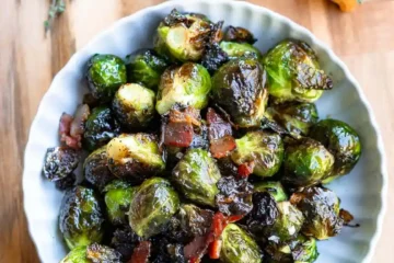 A bowl of roasted brussels sprouts with bacon.