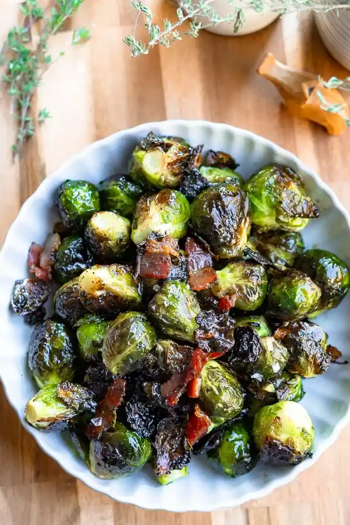 A bowl of roasted brussels sprouts with bacon.