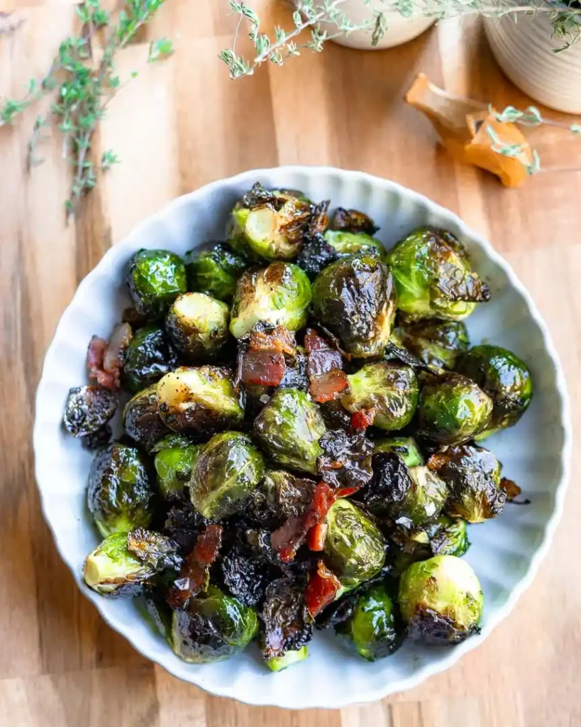 A bowl of roasted brussels sprouts with bacon.