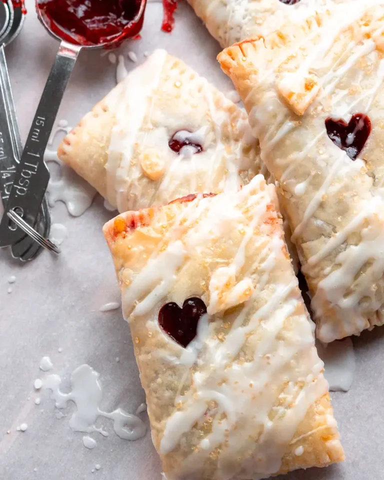 Gluten-Free cherry turnovers with a glaze piled on top of each other.