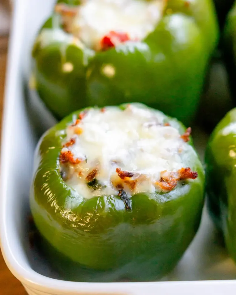 A baked stuffed pepper with melted mozzarella cheese on top.