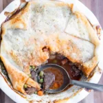 Beef pot pie with a scoop missing.