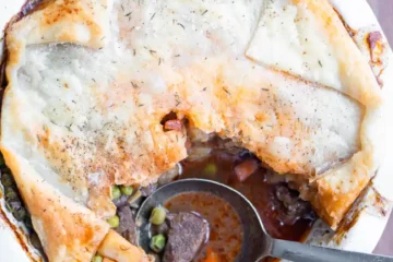 Beef pot pie with a scoop missing.