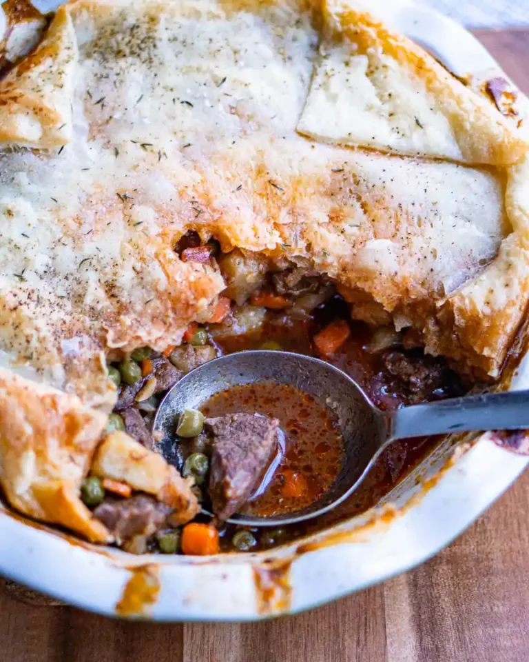 Beef pot pie with a scoop missing.