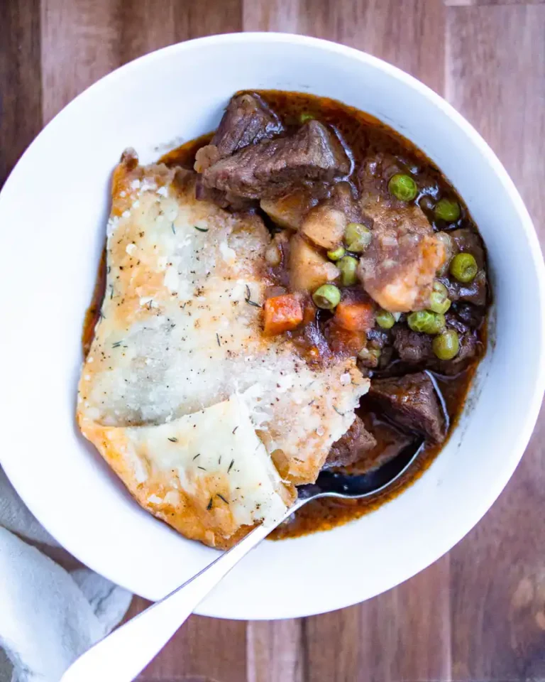 A bowl with a scoop of beef pot pie.