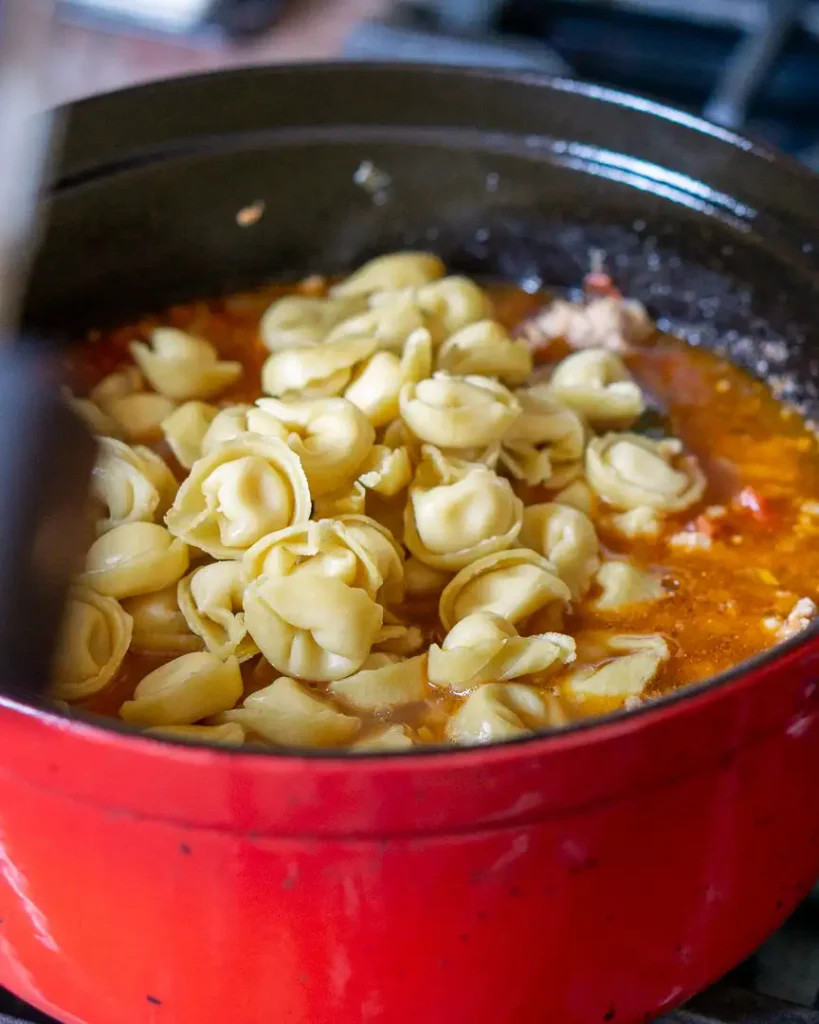 Tortellini in a soup pot.